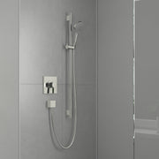Chrome wallbar shower set with handheld showerhead, vertical rail, and dual control handles mounted on bathroom tile wall.