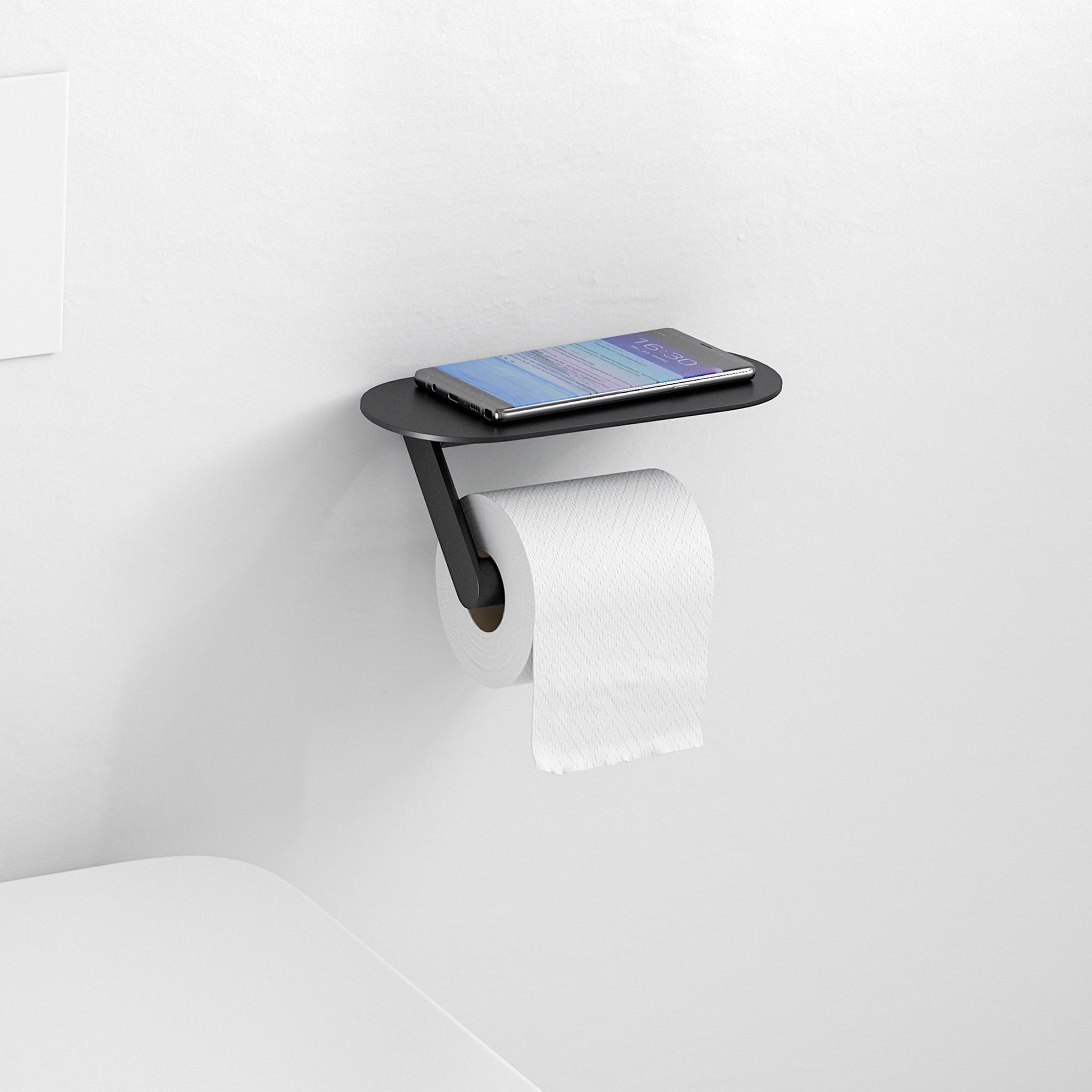 Matte black wall-mounted toilet paper holder with shelf holding a smartphone and roll of toilet paper.