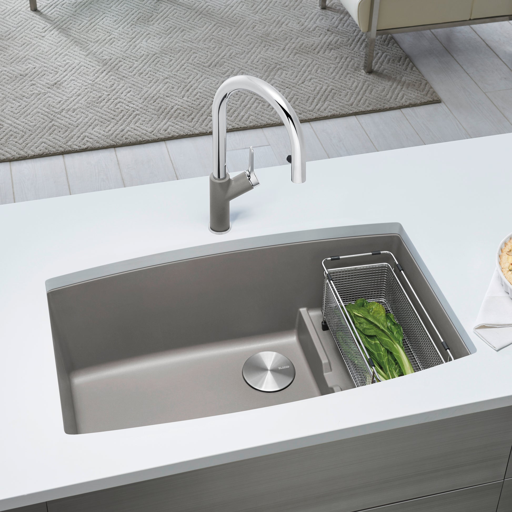 Undermount kitchen sink in truffle gray composite with single basin, drain plug, and matching pull-down faucet in chrome fini