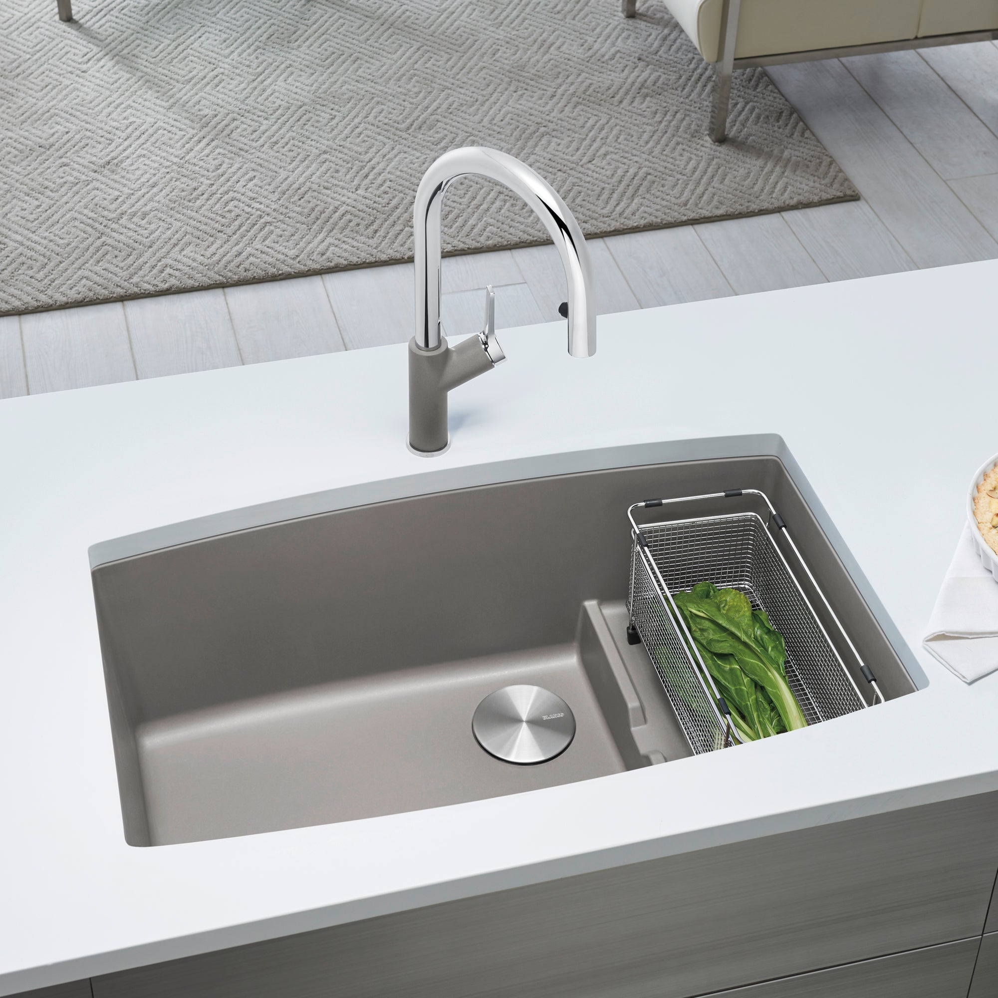 Undermount kitchen sink in truffle gray composite with single basin, drain plug, and matching pull-down faucet in chrome fini