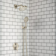 Polished nickel shower system with overhead rain showerhead, handheld wand, and wall-mounted control valve on subway tile bac