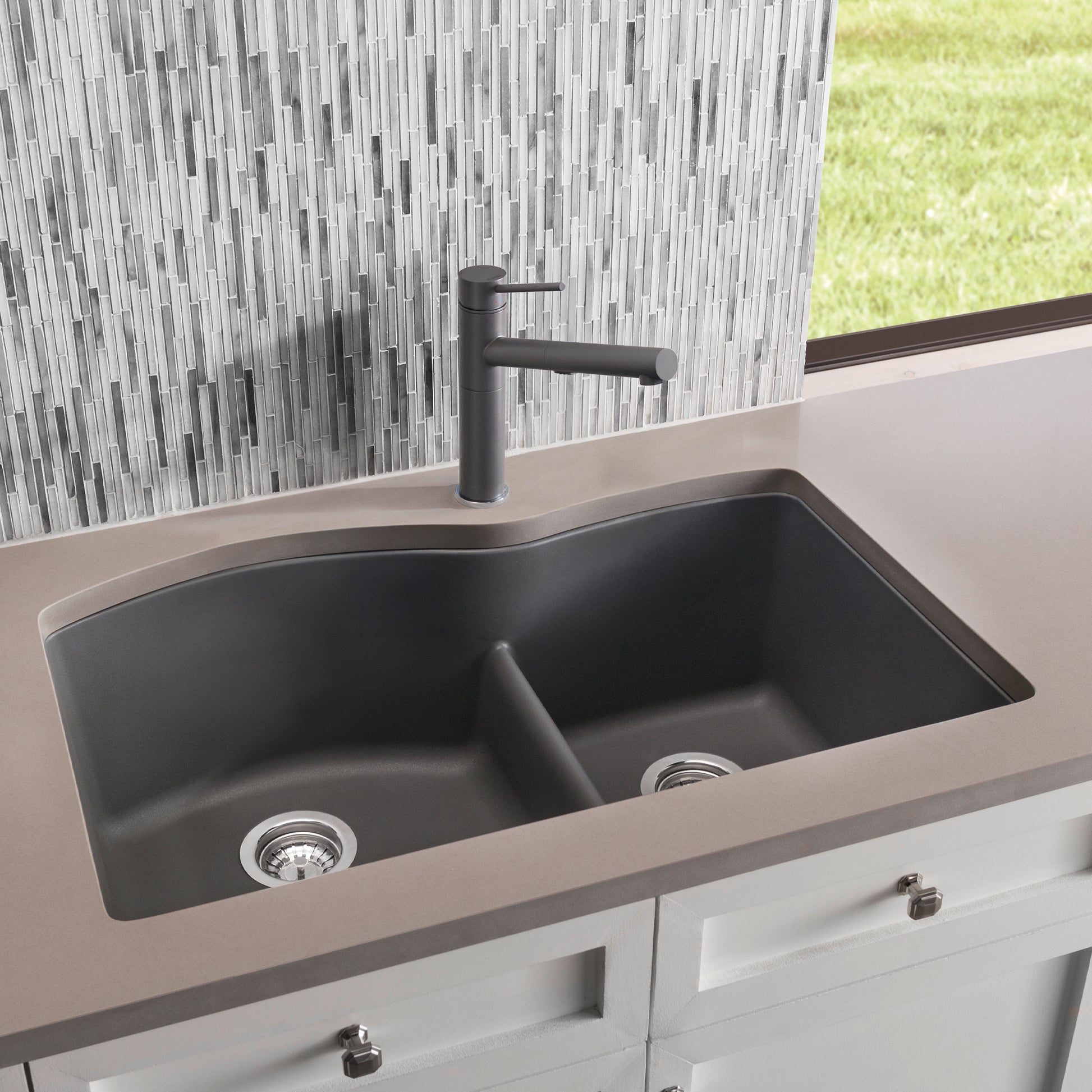 Cinder gray undermount kitchen sink with two equal basins, low divide, and matching single-handle faucet installed in counter