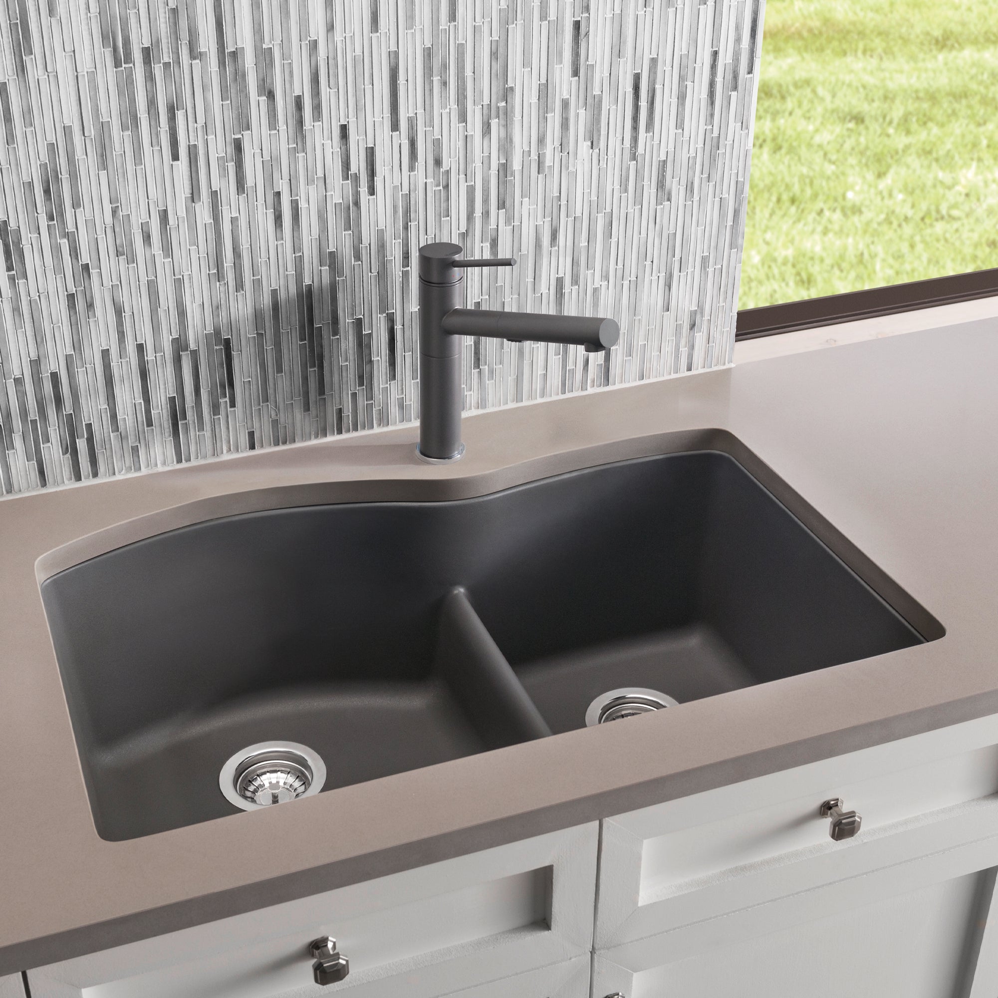 Cinder gray undermount kitchen sink with two equal basins, low divide, and matching single-handle faucet installed in counter