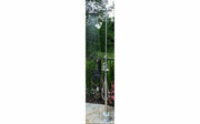 Stainless steel freestanding outdoor shower unit with overhead showerhead and handheld shower sprayer mounted on pole.