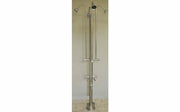 Stainless steel freestanding outdoor shower with four spray heads, foot shower valve, and hose faucet attachment on vertical 