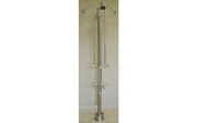 Free-standing metal outdoor shower fixture with four spray heads, curved arms, foot pedal, and hose connection.
