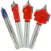 Four router bits with red cutting heads and gray metal shanks, including three V-groove bits and one angled bit.