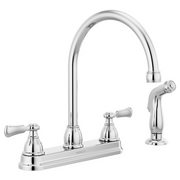 Chrome two-handle kitchen faucet with curved spout, spray attachment, and lever handles on white background.