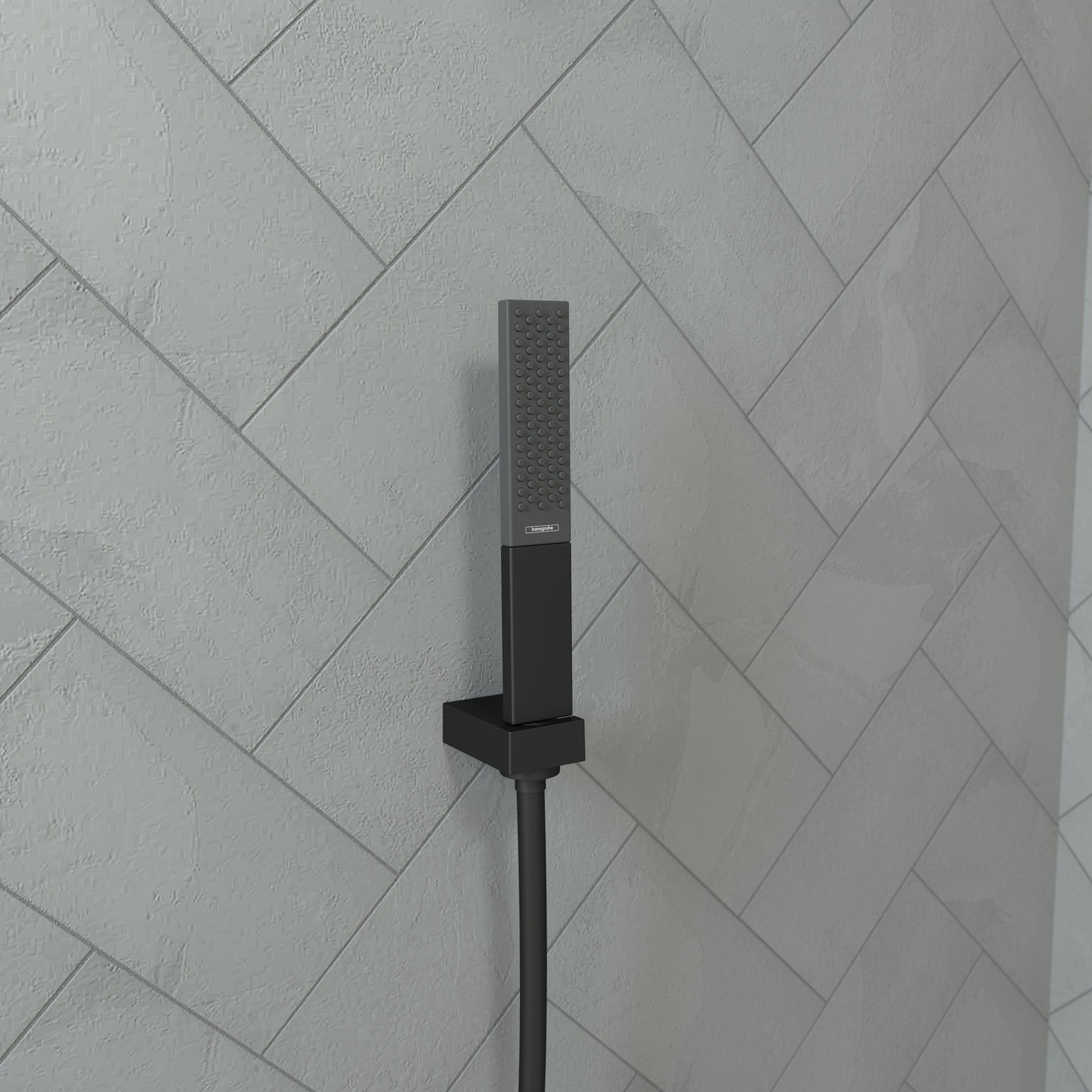 Matte black rectangular handheld showerhead with perforated nozzle mounted on wall tile with attached hose.