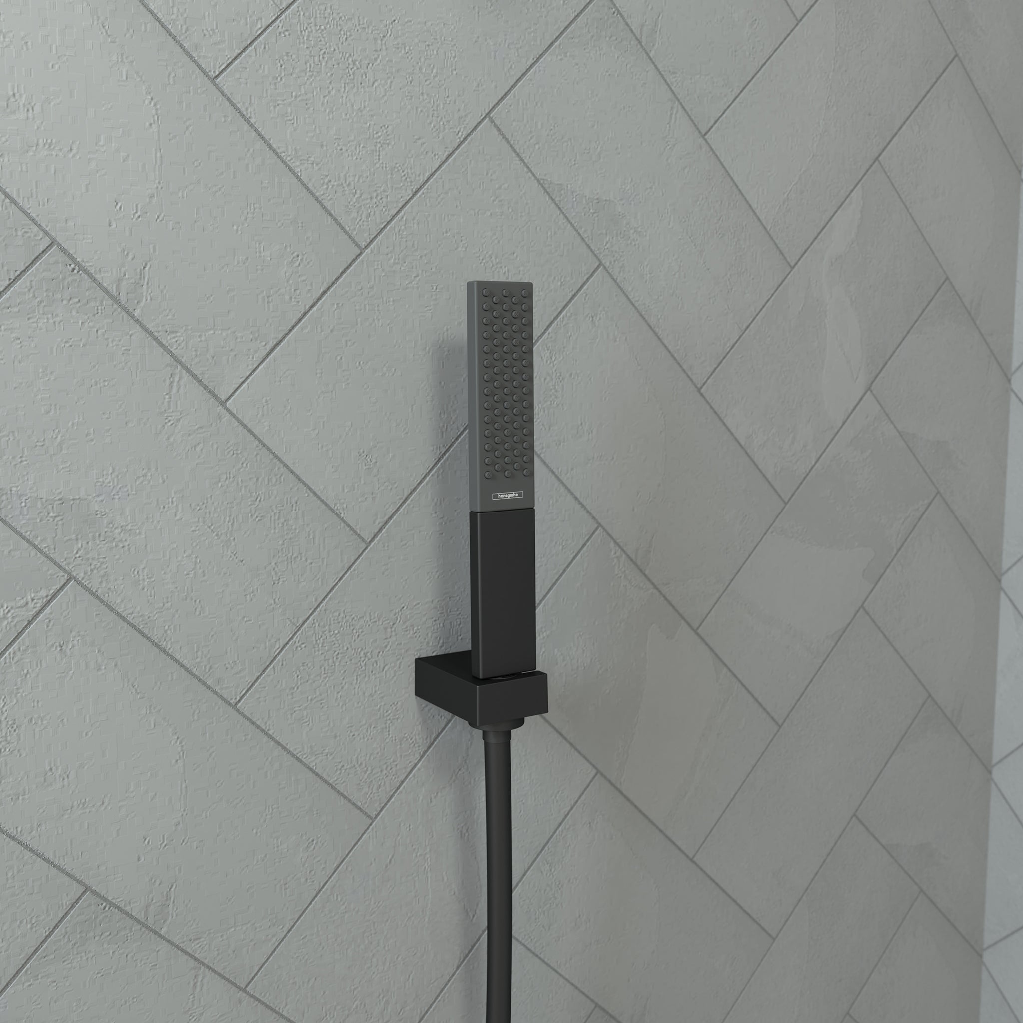 Matte black rectangular handheld showerhead with perforated nozzle mounted on wall tile with attached hose.