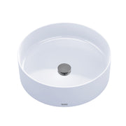White round vessel sink with chrome drain cap, viewed from above.