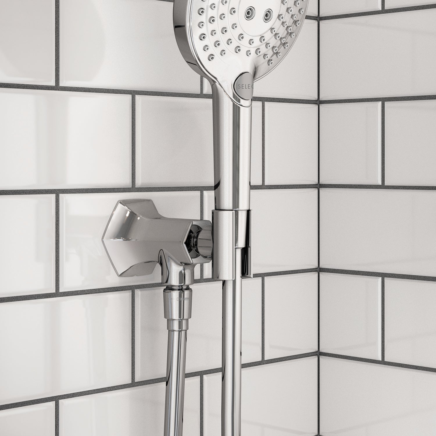 Chrome handshower holder with outlet mounted on white subway tile wall, featuring perforated showerhead above.