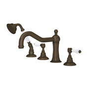 Tuscan brass four-piece deck mount tub filler with curved spout, showerhead, and white porcelain lever handles.