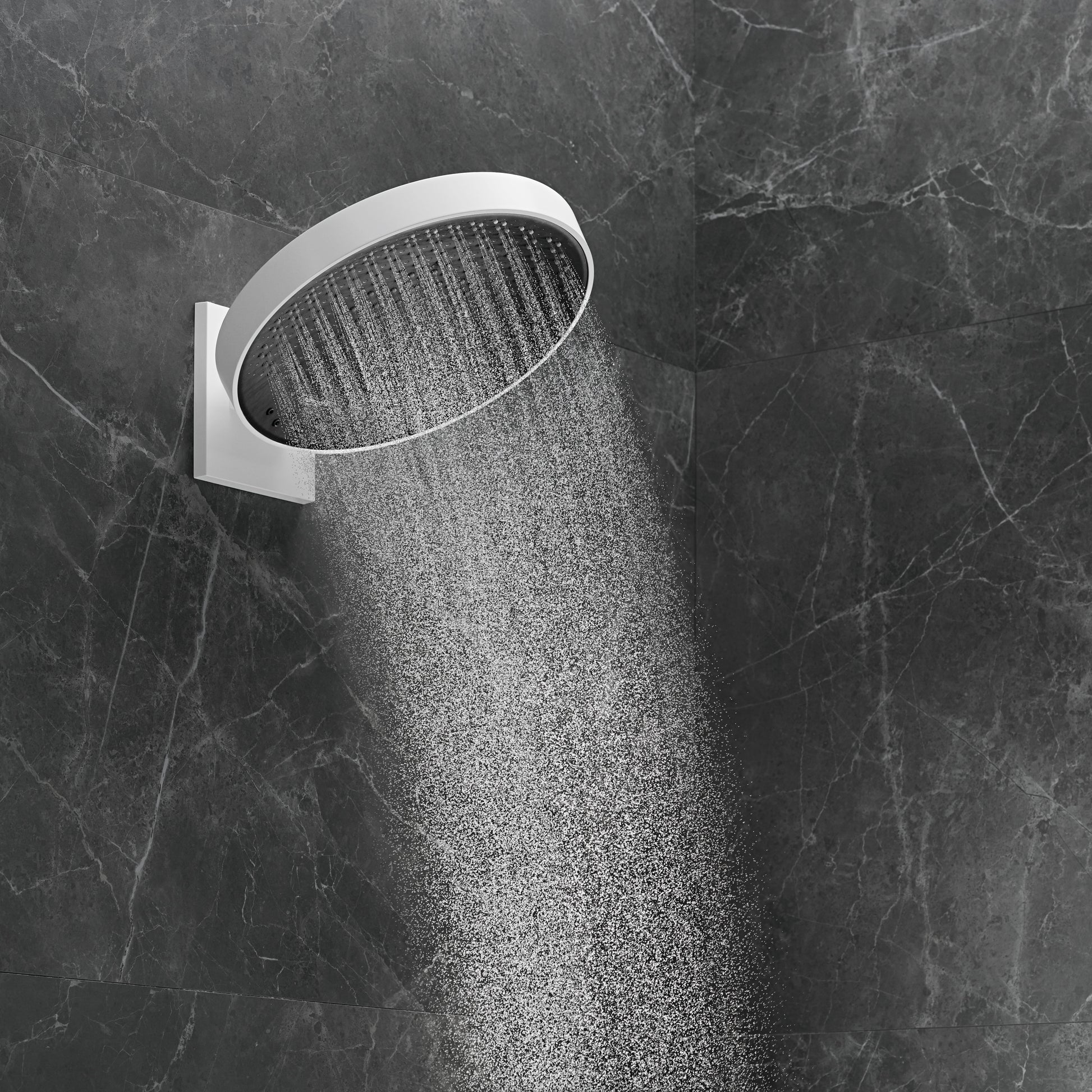 Matte white round shower head with perforated spray pattern mounted on gray marble tile wall.