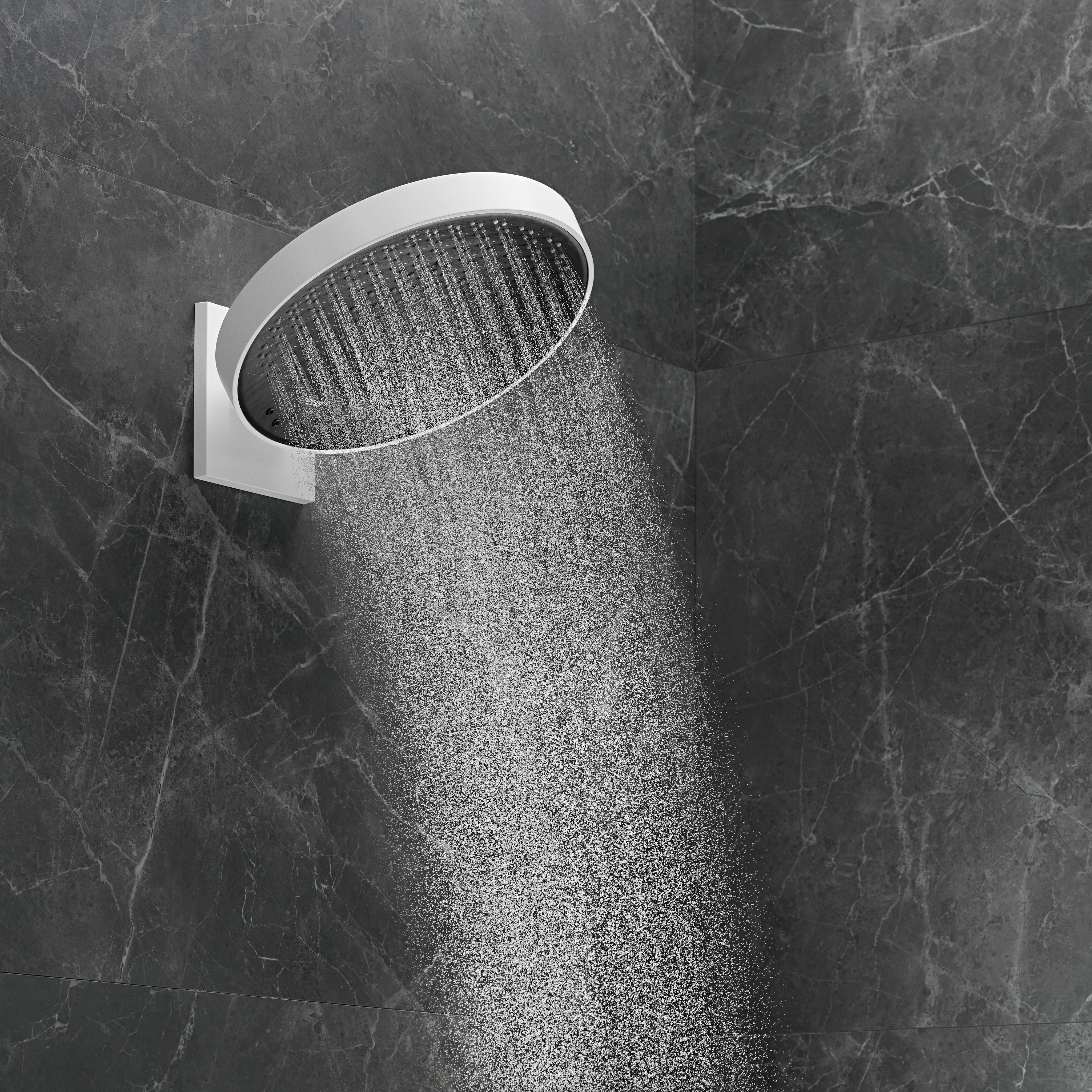 Matte white round shower head with perforated spray pattern mounted on gray marble tile wall.