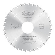 Circular saw blade with conical scoring teeth, silver finish, center hole, and engraved Freud branding and specifications.