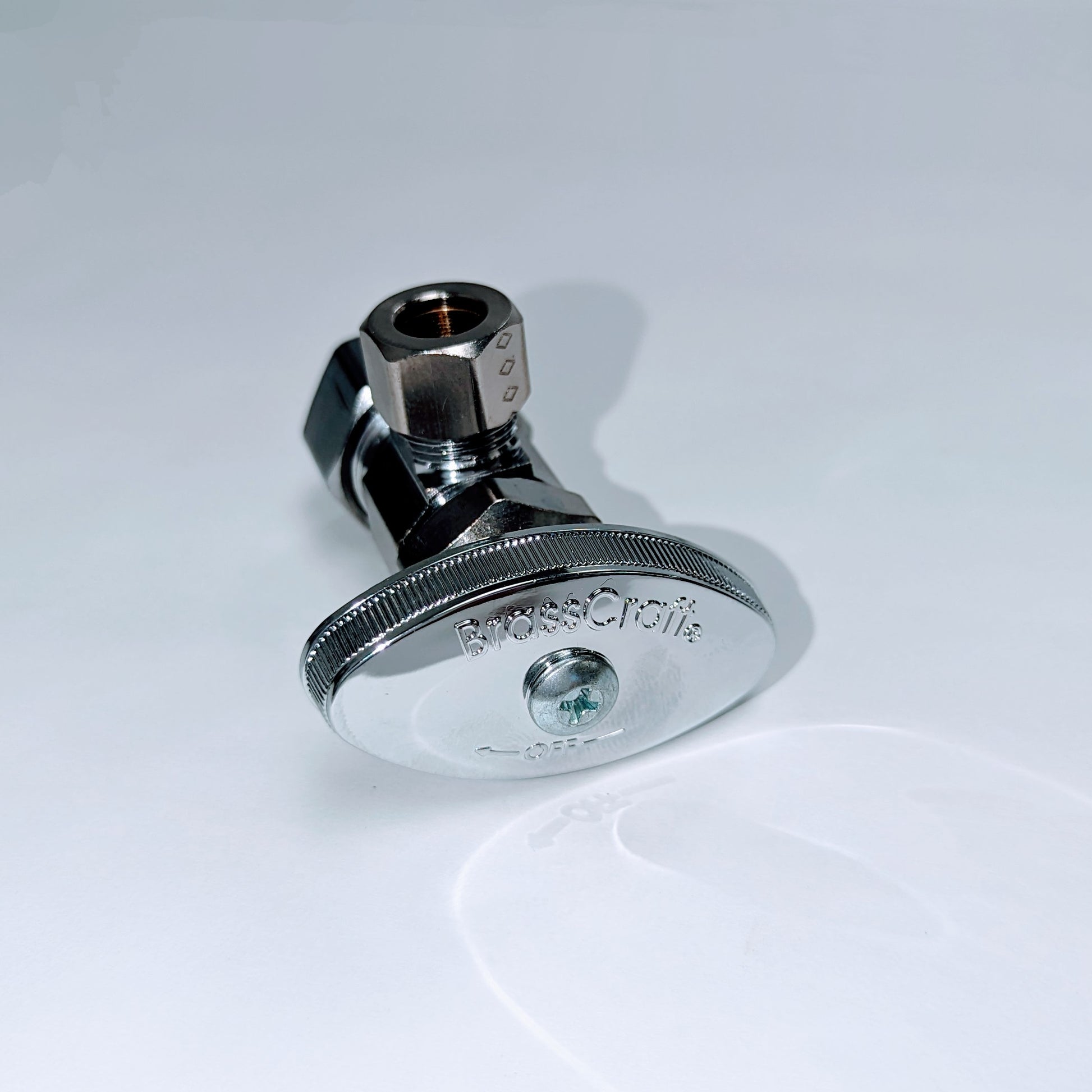 Chrome angle valve with hexagonal nut connector at top and circular escutcheon plate at base with adjustment screw.