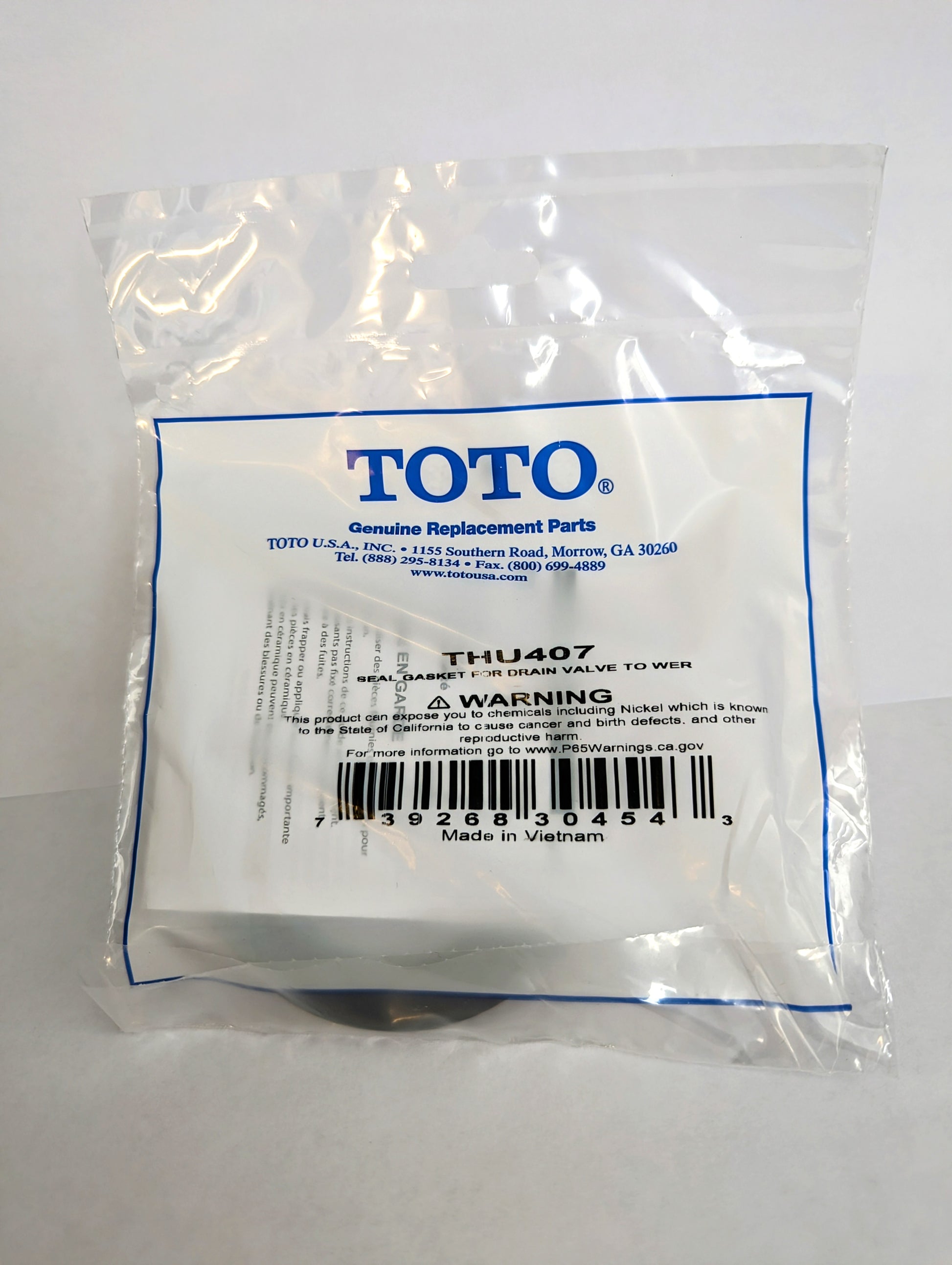 Toto THU407 seal gasket for drain valve tower in clear plastic packaging with blue TOTO branding and barcode label.