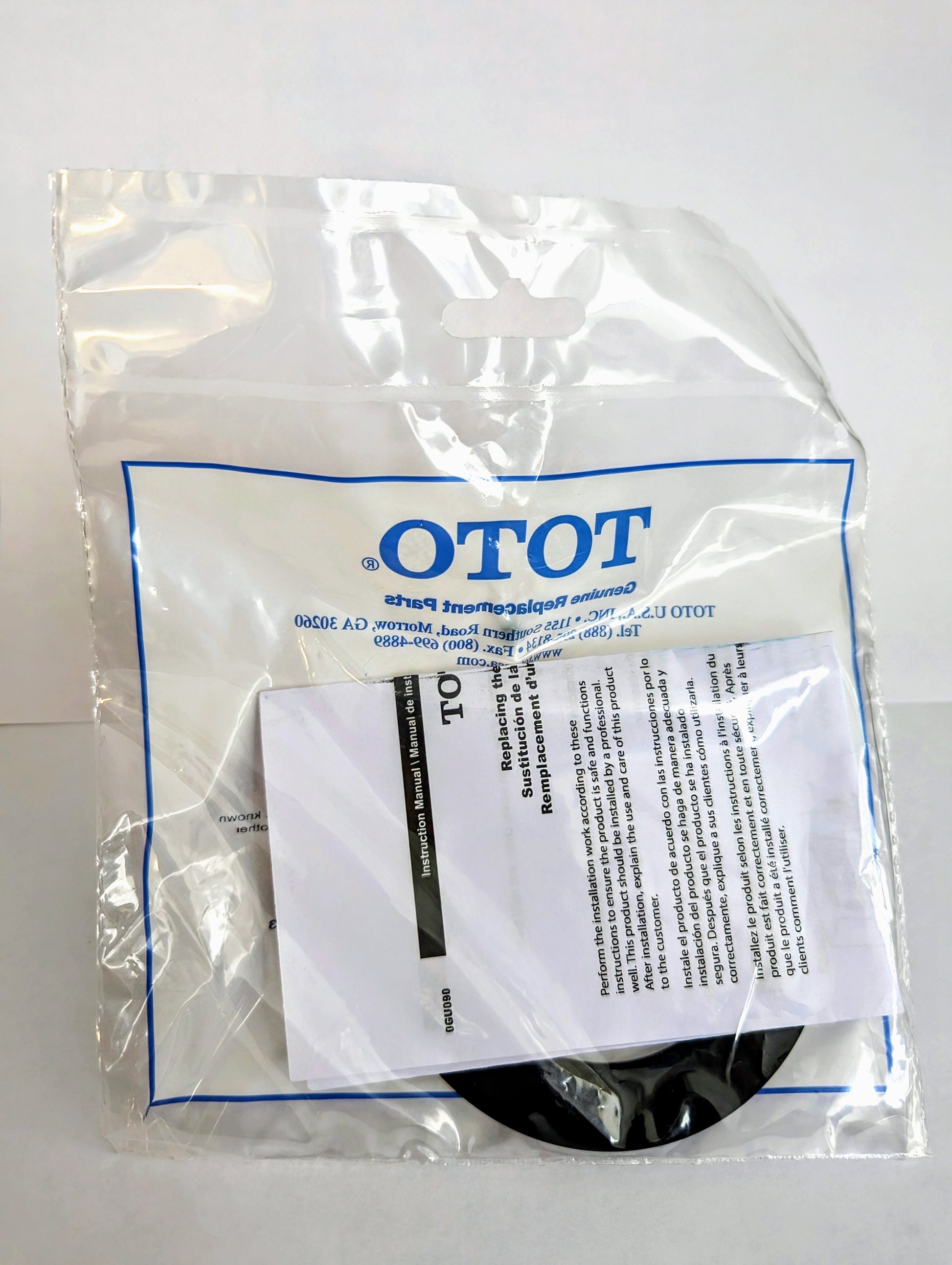 Toto replacement seal gasket in clear plastic packaging with instruction label and black rubber component visible.