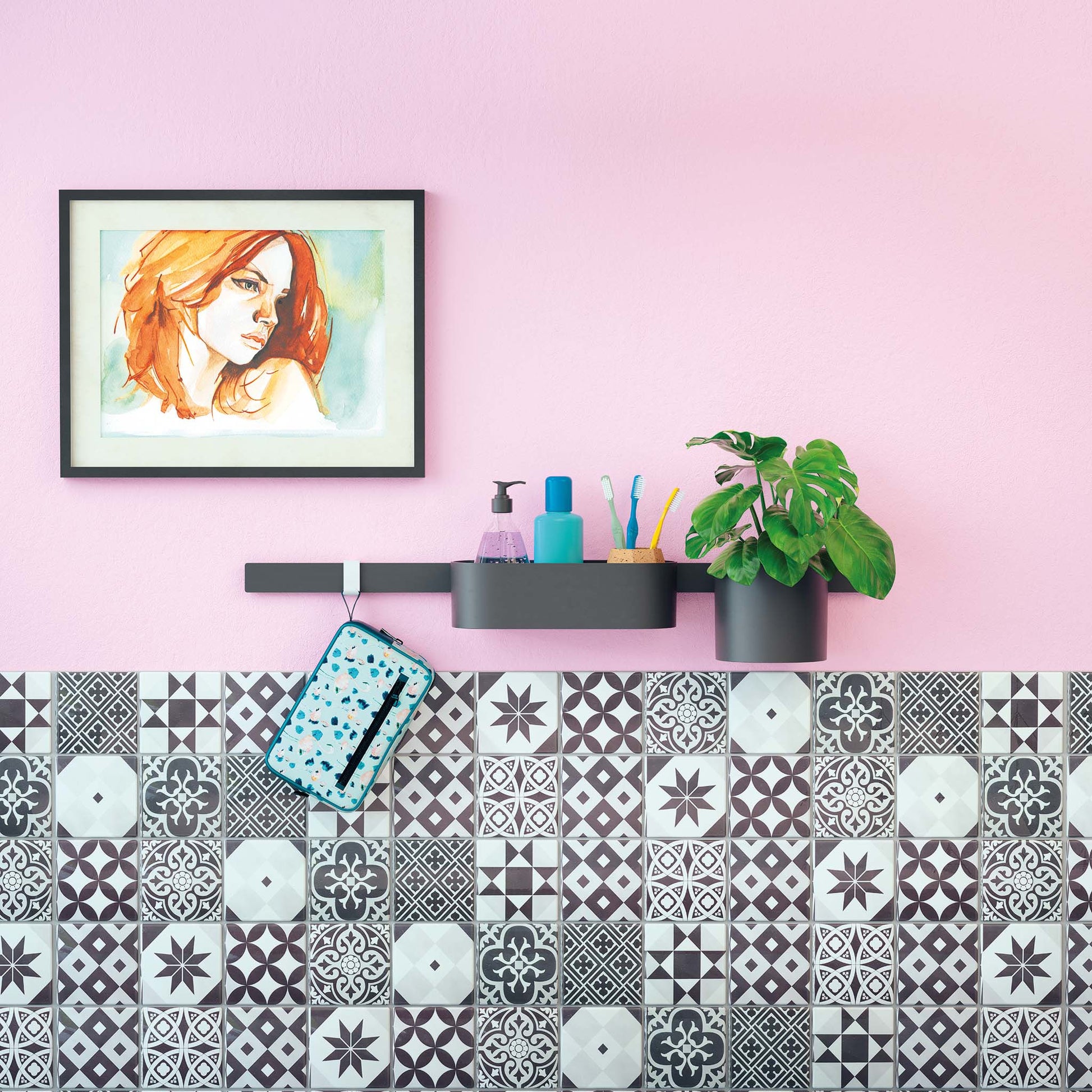 Matte white wide towel hook mounted on pink wall above patterned tile backsplash.
