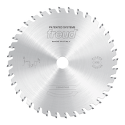 Circular saw blade with conical scoring teeth around perimeter, central hole, and Freud branding on silver metal surface.