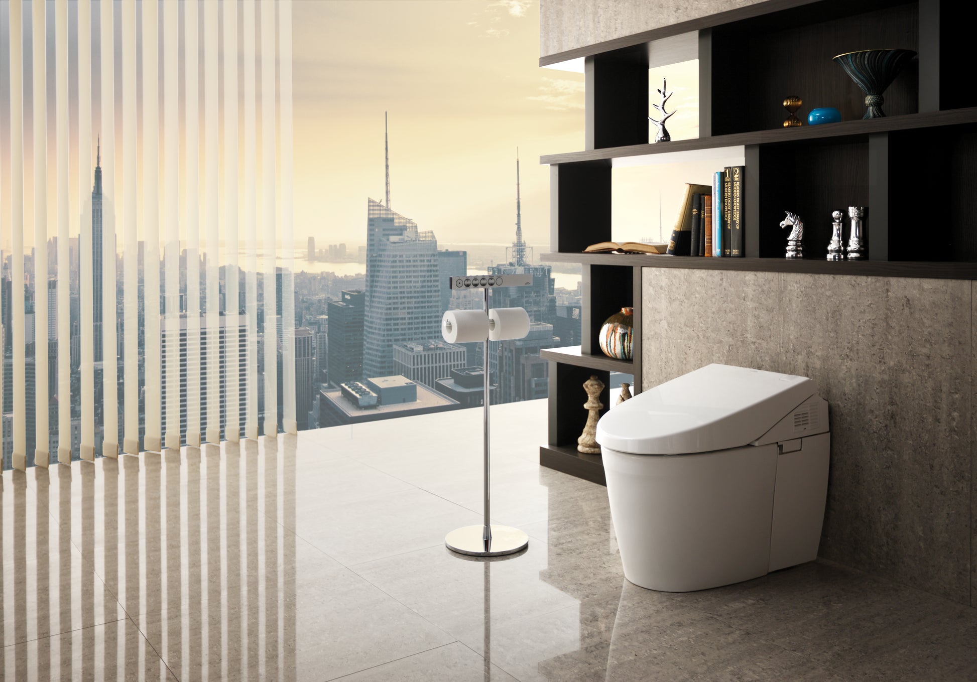 Polished chrome stand with round base holding a remote control, displayed next to a white toilet.