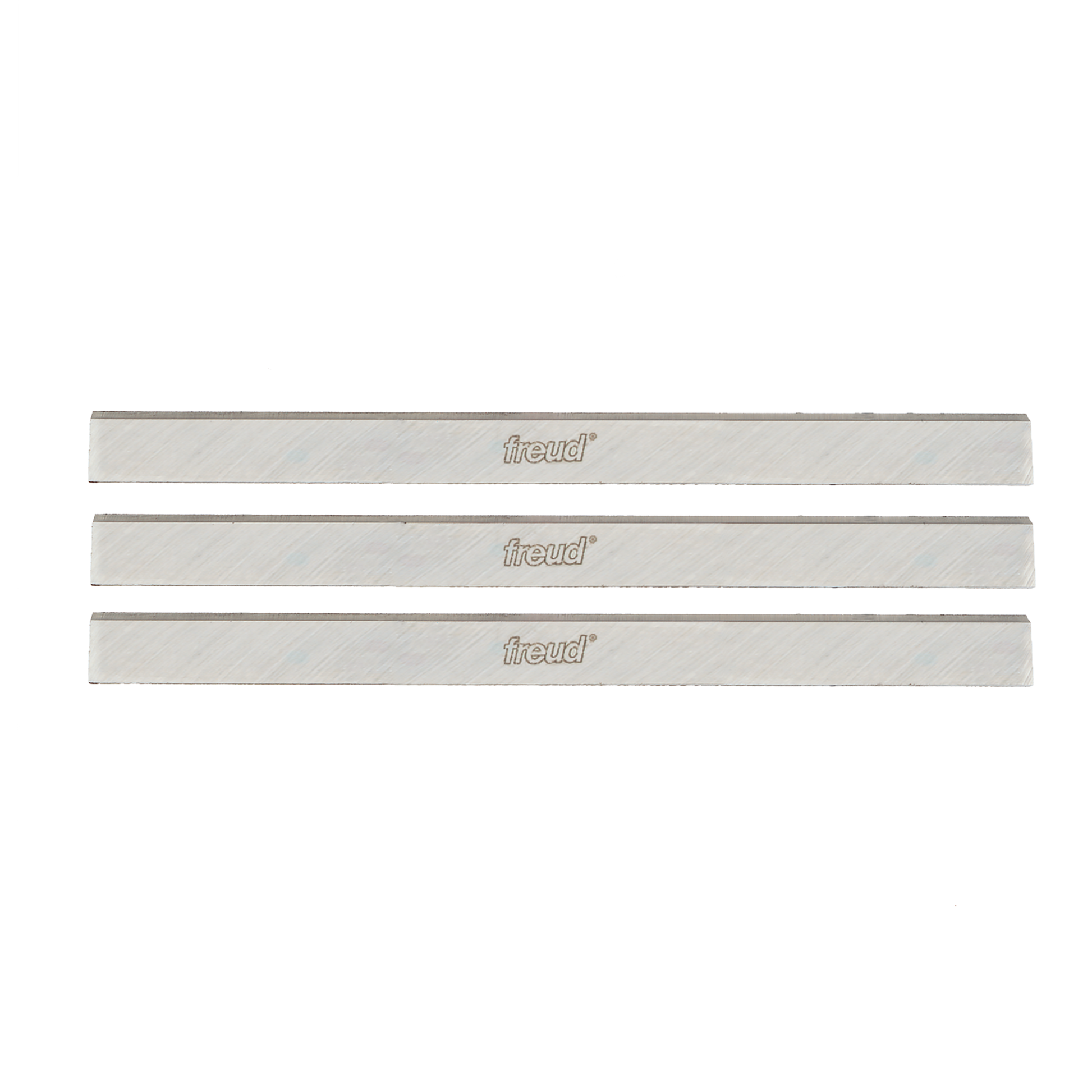 Three silver rectangular planer and jointer knife blades with Freud branding stamped on surface.