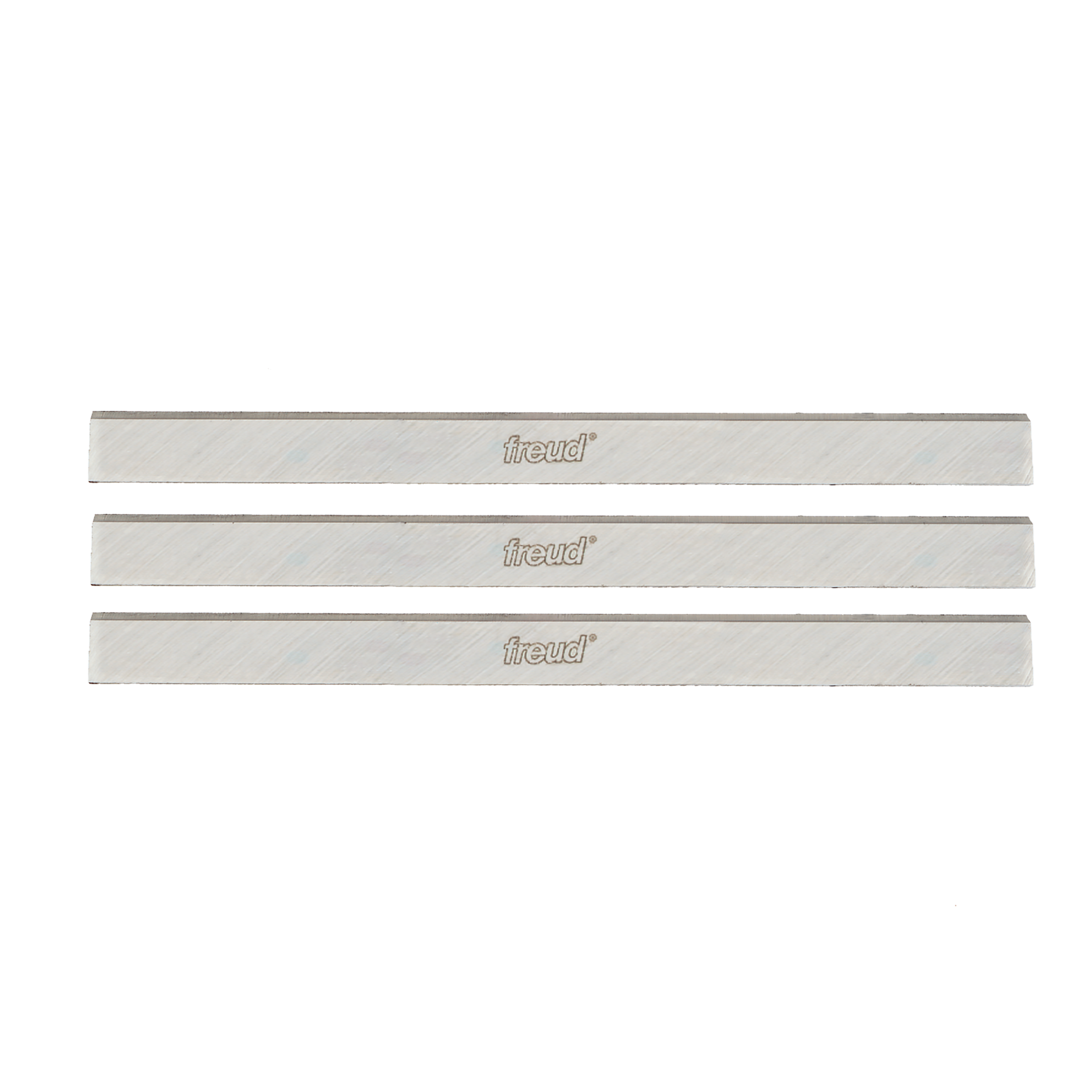 Three silver rectangular planer and jointer knife blades with Freud branding stamped on surface.
