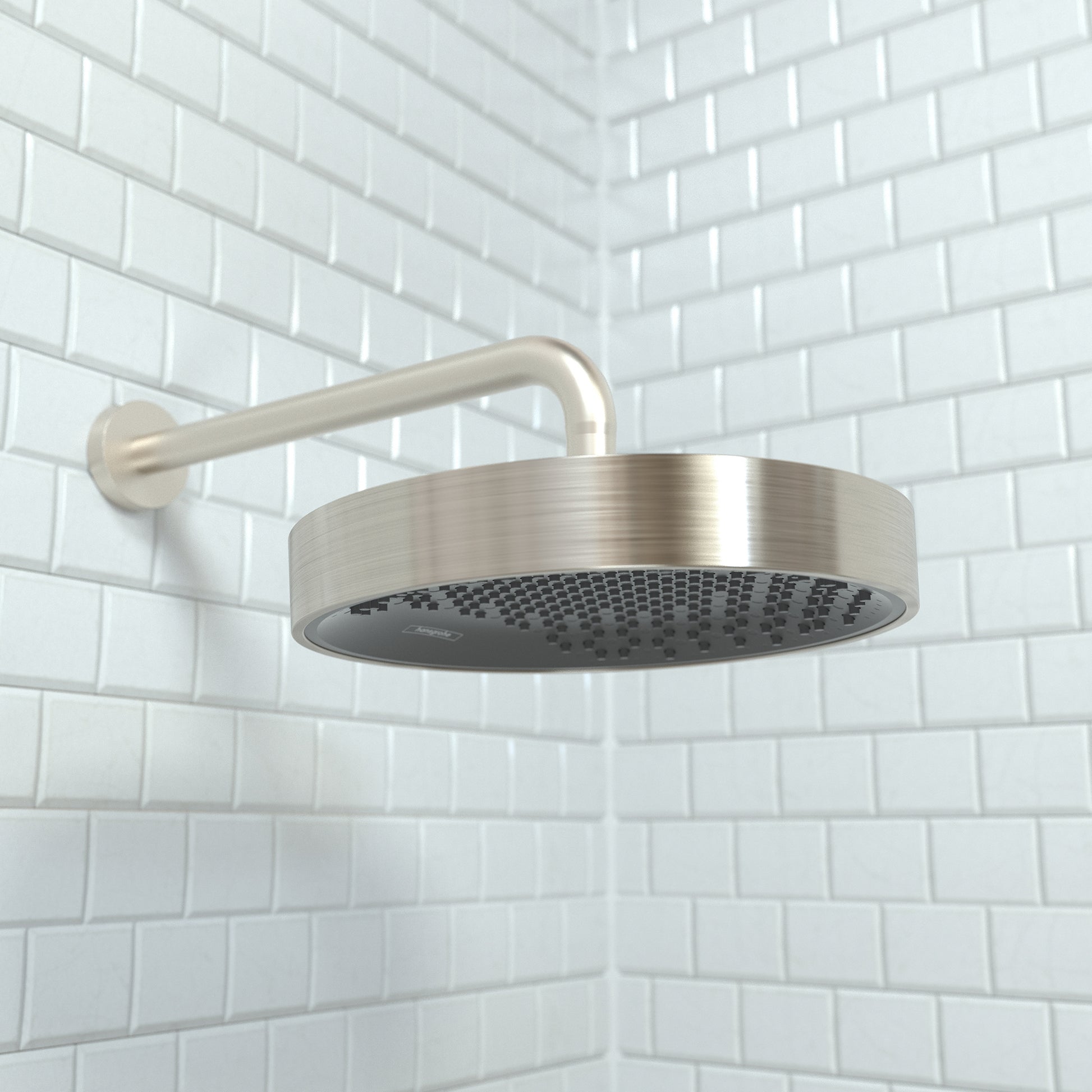 Brushed nickel round shower head with curved arm mounted on white subway tile wall.