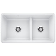 White double bowl undermount kitchen sink with low divide and chrome drain strainers.