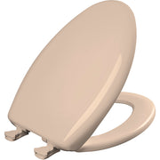 Elongated beige plastic toilet seat with soft-close hinge and metal fastening hardware visible at base.