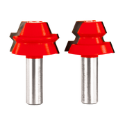Two red lock miter router bits with silver metal shanks and notched cutting edges.