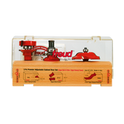 Three red router bits with various cutting profiles displayed in clear plastic case over wooden base with labeled diagrams.