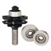 Stacked slotting router bit set with metal shank, black stackable cutters, and two white bearing wheels with ball bearings.