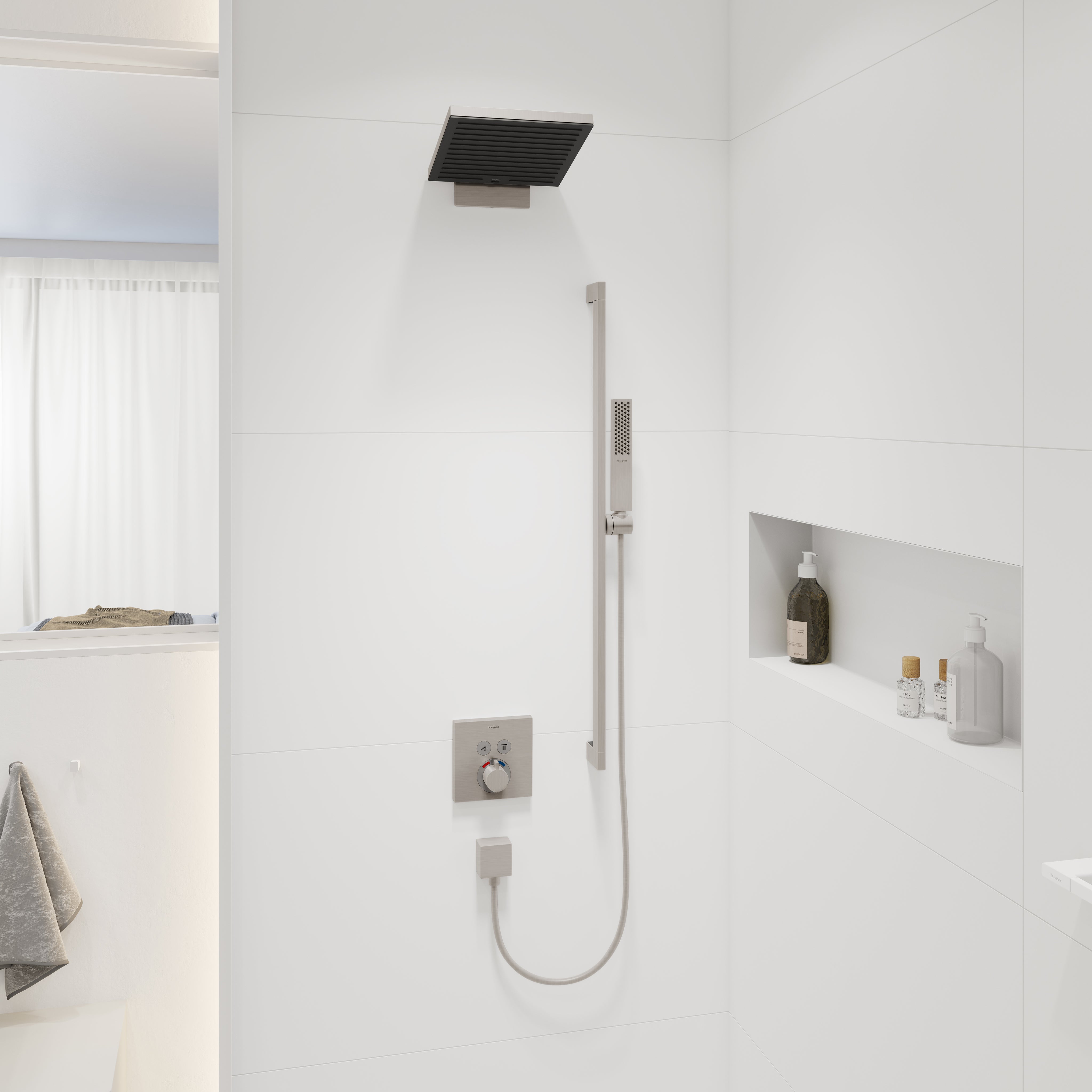 Brushed nickel rectangular shower head mounted on ceiling above white tile shower wall with handheld spray below.
