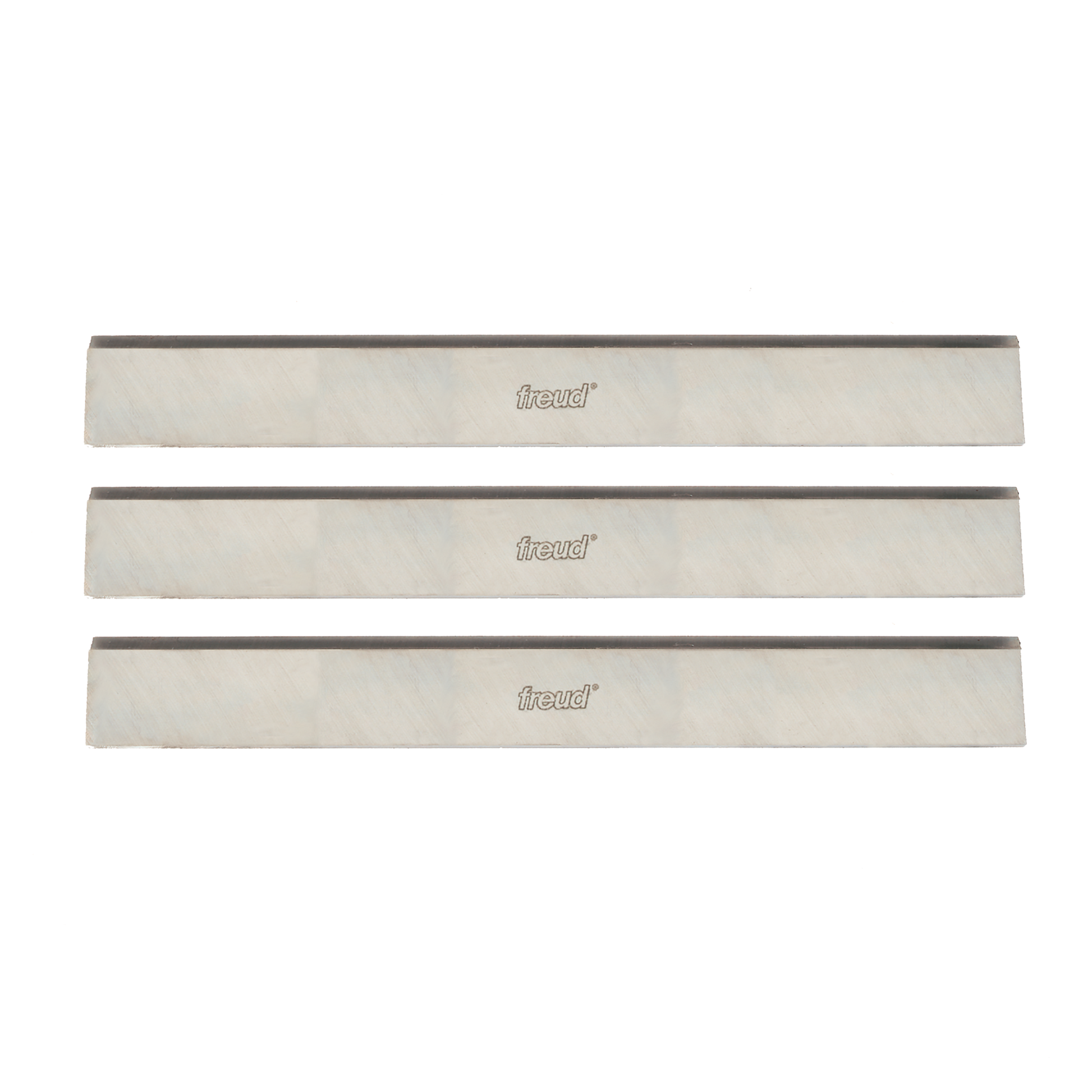 Three rectangular high speed steel planer knives with dark cutting edges and Freud branding on light bodies.