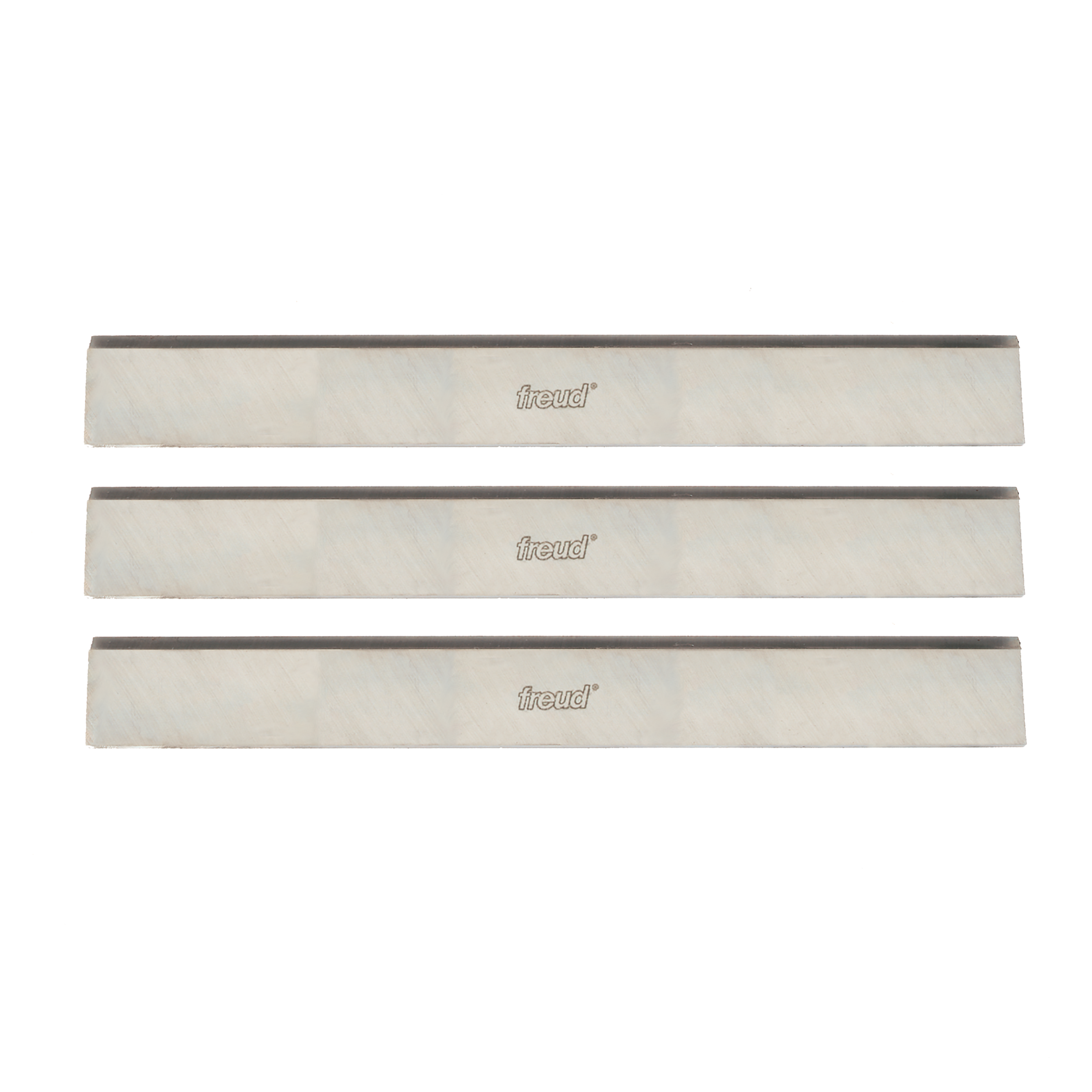 Three rectangular high speed steel planer knives with dark cutting edges and Freud branding on light bodies.