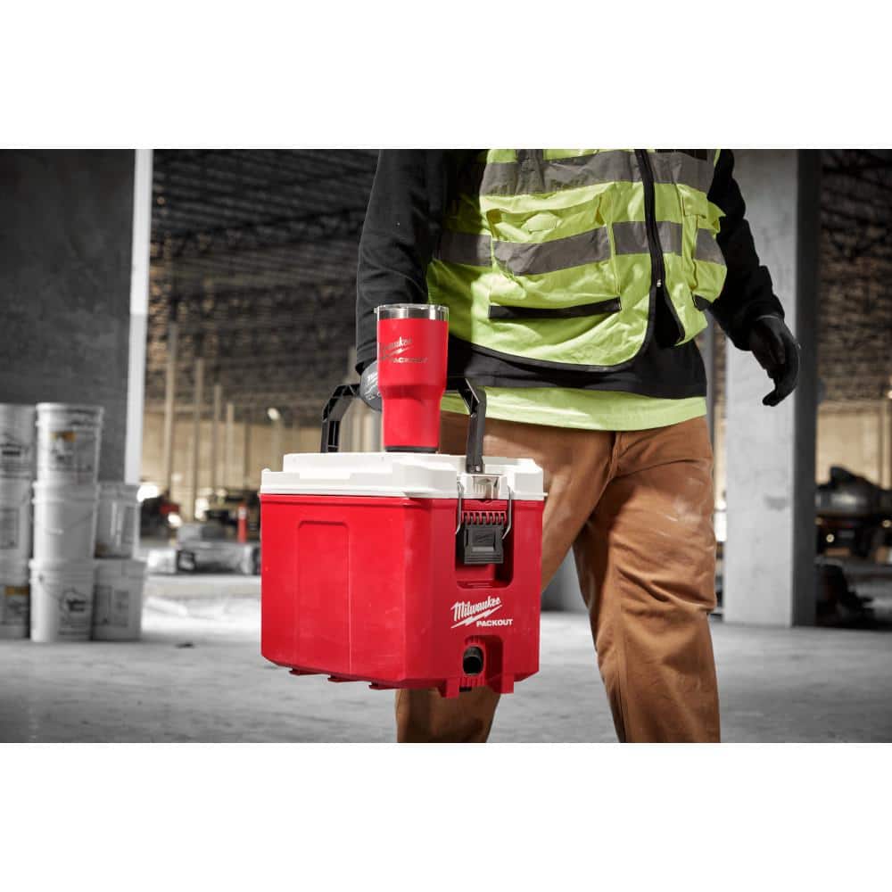 Red Milwaukee Packout tumbler and cooler set displayed together on a jobsite.