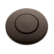 Oil rubbed bronze circular push button air switch with recessed center button on round mounting plate.