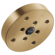Round champagne bronze shower head with nine spray ports arranged in a circle around a center Delta logo.