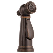 Venetian bronze kitchen faucet sprayer head with adjustable spray pattern and attached hose on cylindrical base.