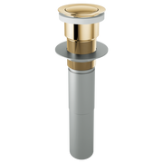Polished gold push button pop-up drain assembly with gray pipe and threaded brass connector, shown fully assembled.