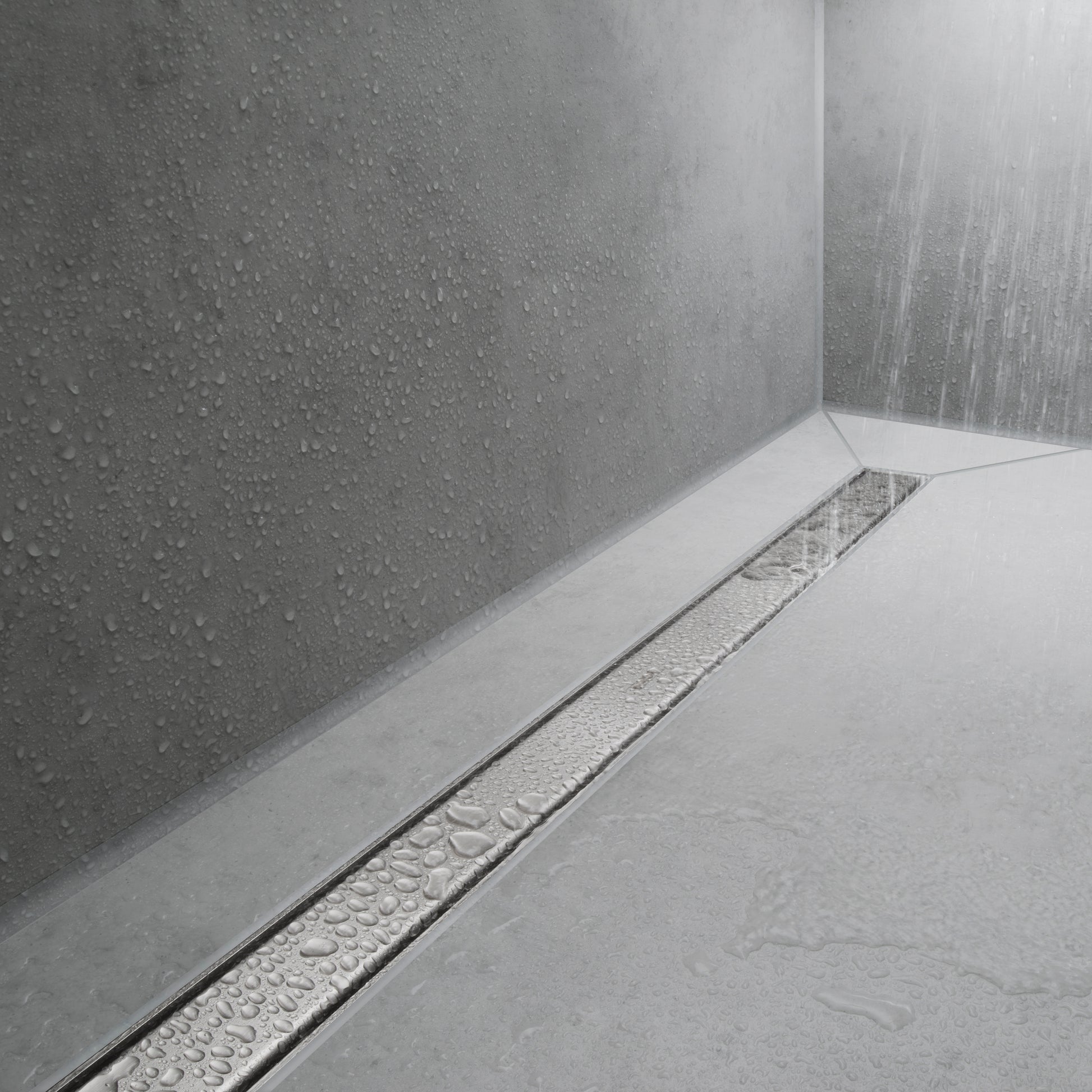 Brushed stainless steel linear floor drain installed in white tile shower with water flowing down textured gray walls.