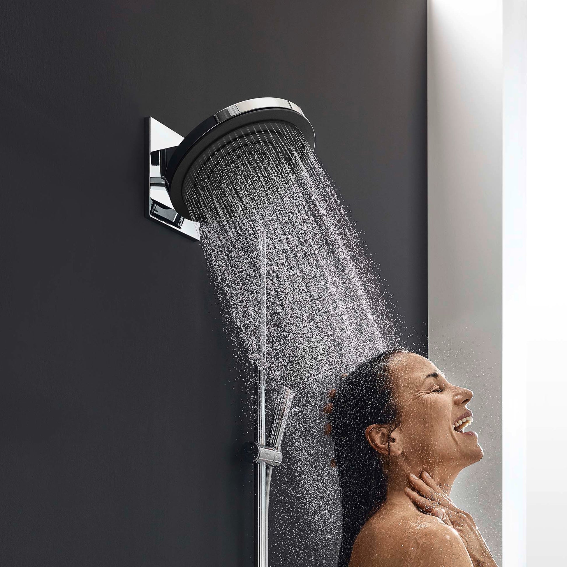 Chrome wall-mounted showerhead with 3-jet spray pattern and adjustable arm bracket dispensing water.