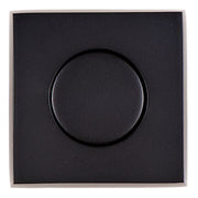 Square matte black air switch push button with circular raised center on flat faceplate.