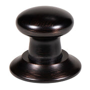 Oil-rubbed bronze push button air switch with mushroom-shaped cap and circular base.