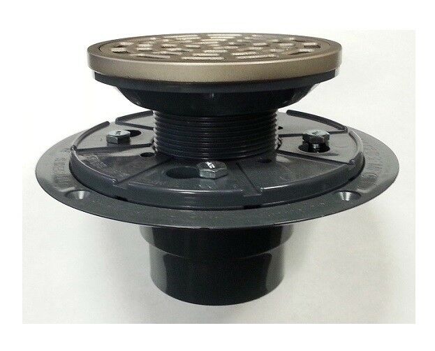 Satin nickel round shower drain strainer with perforated top and black adjustable ring assembly for installation.