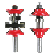 Two red and silver router bits with interchangeable cutting heads and black components on metal shanks.