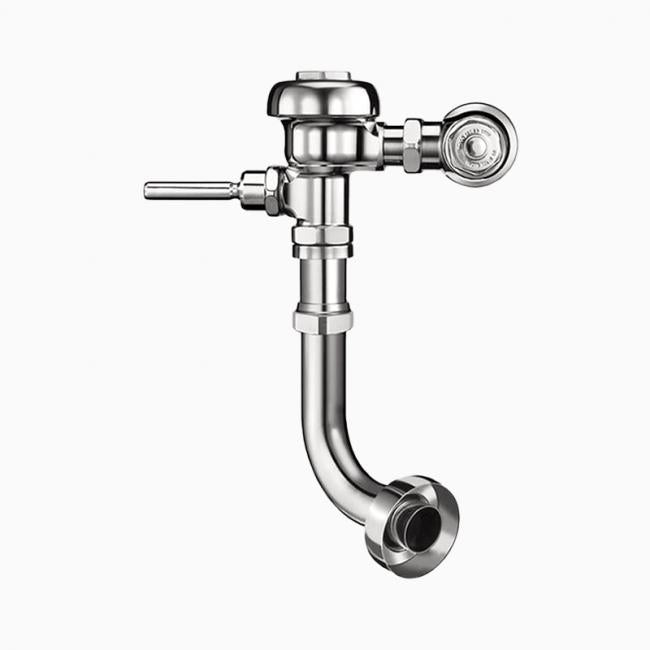 Chrome exposed flushometer with round actuator button, inlet connection, and curved outlet pipe.