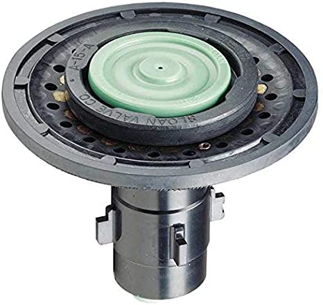 Circular flushometer valve assembly with green diaphragm and black metal housing with mounting brackets.